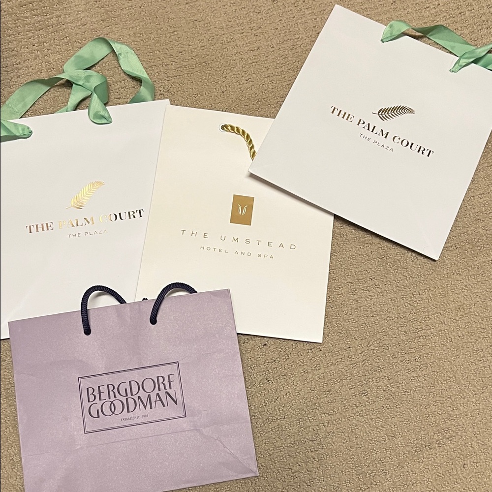 Small shopping bags from the Plaza, the Umstead, and the Palm Court
